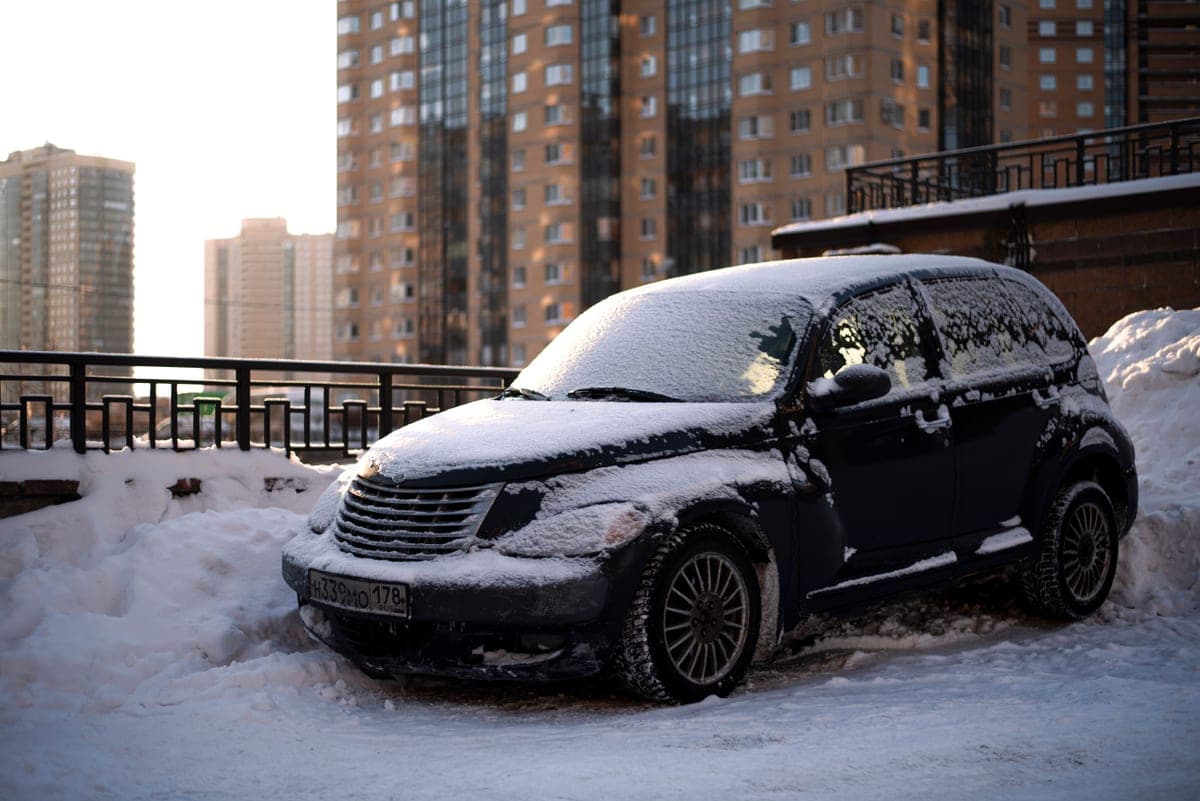 A car covered in snow on a cold morning