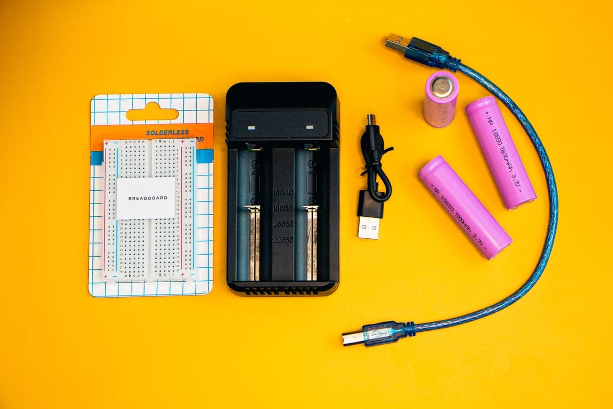 A portable battery and charging equipment on a bench