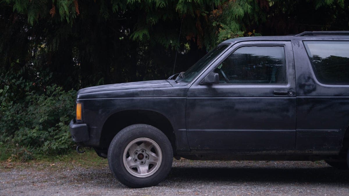 An SUV parked on a gravel road