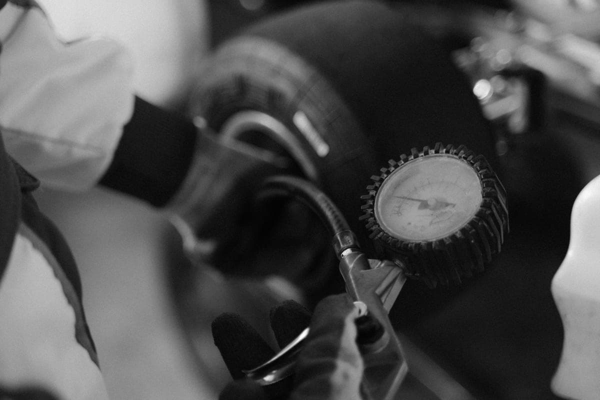A tire pressure gauge held against a wheel