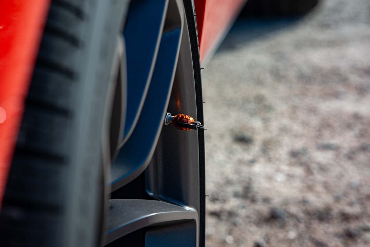 Close-up of a tire valve stem on an alloy wheel